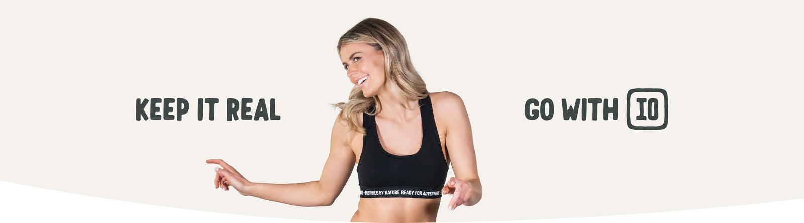 Image shows woman in a sports crop top. Text says 'Keep It Real' and 'Go With IO'