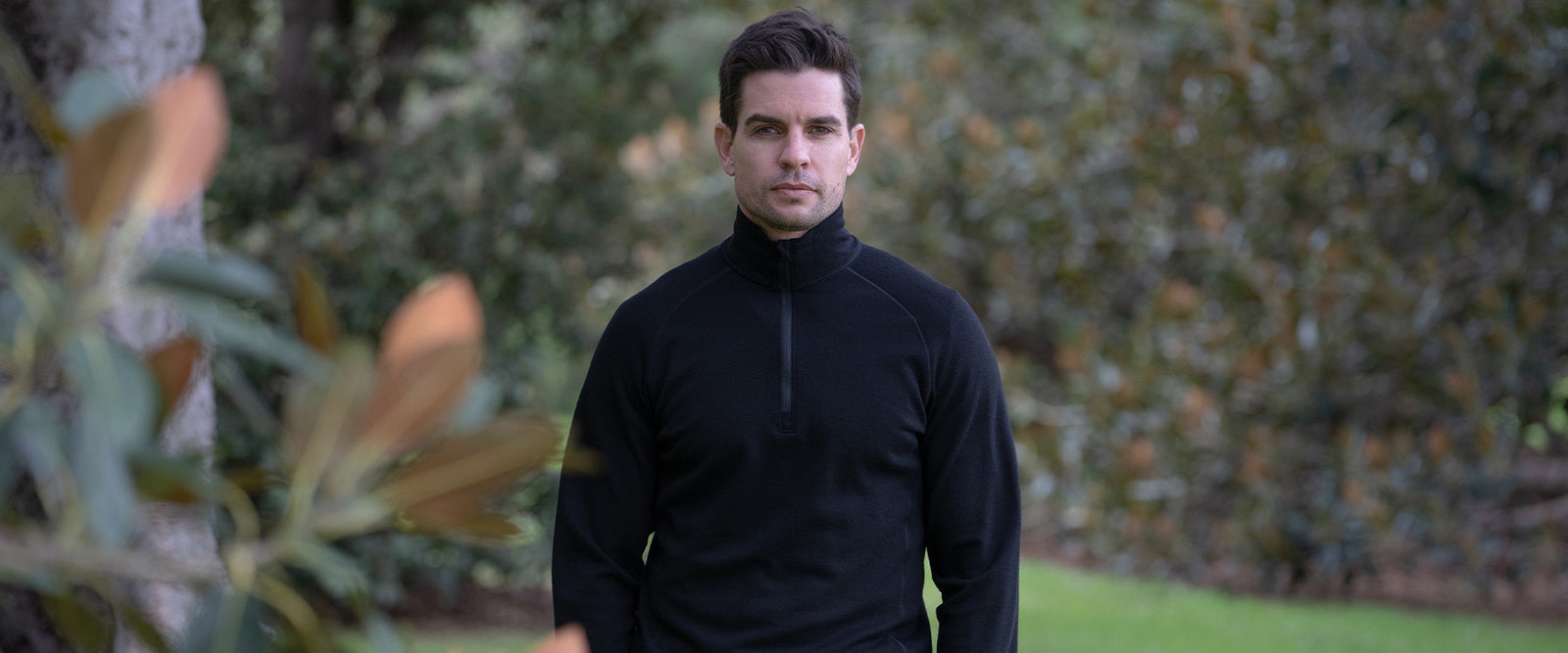 Man wearing black merino wool zip mid layer