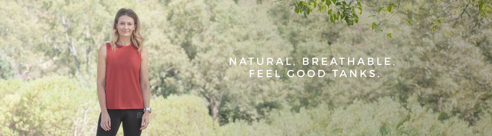 Person sitting in the outdoors with green hills in the background