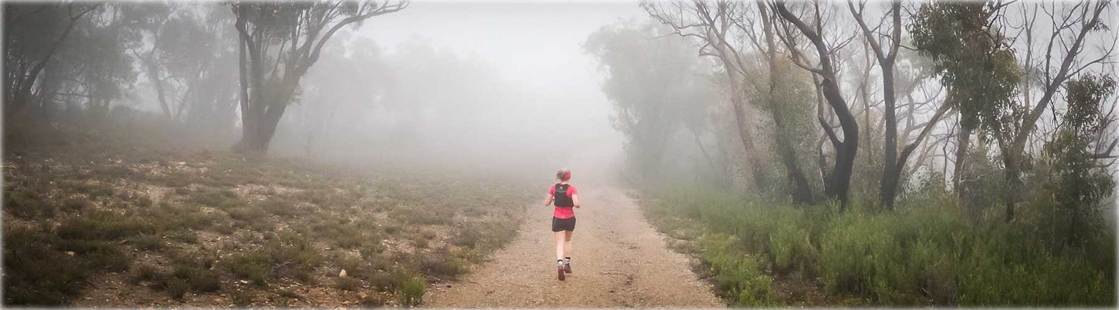 Woman trail running in the Australian bush