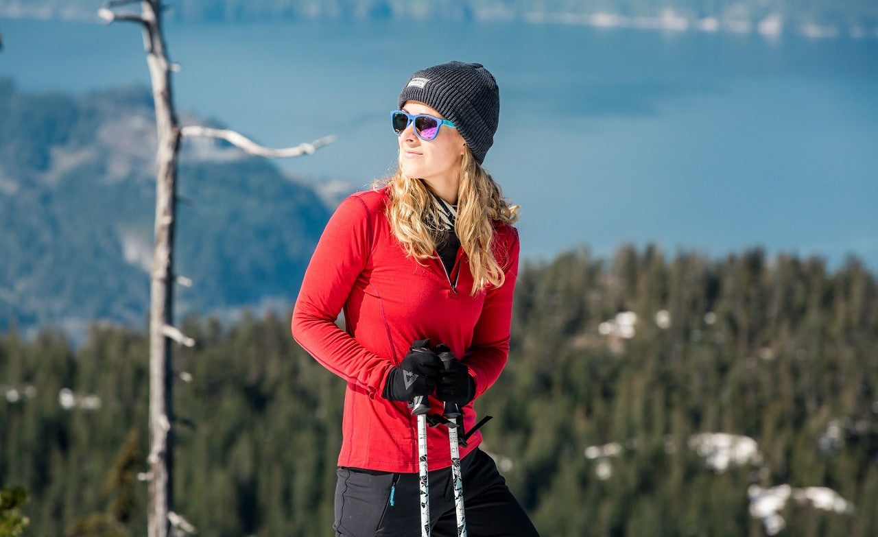 Woman in the snow wearing ioMerino outdoor clothing