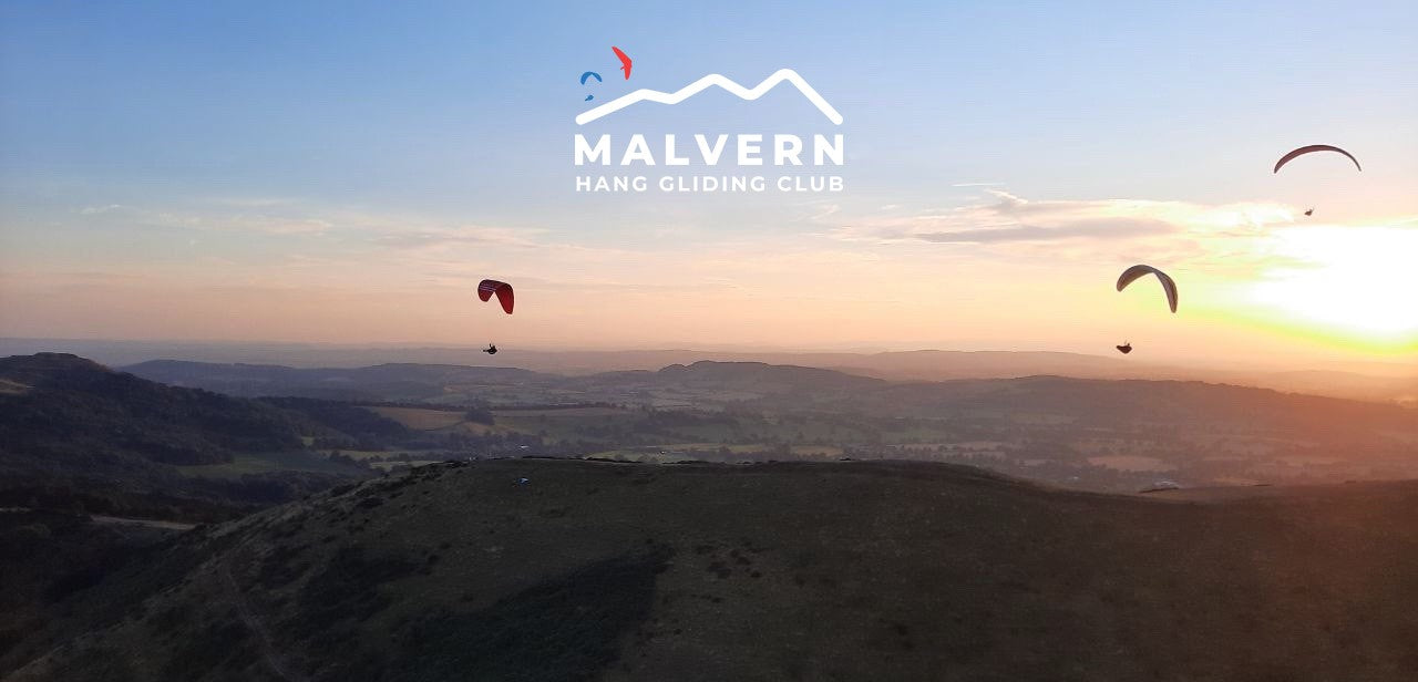 Malvern Hang Gliding Club image showing hang gliders flying over the hills