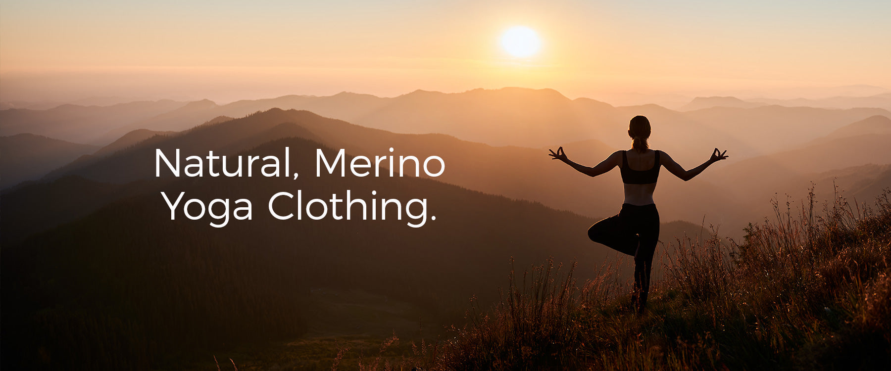 Image of person on a mountain, in a yoga pose, silhouetted by the sun in the distance. Text in white to the left 'Natural, Merino Yoga Clothing'.